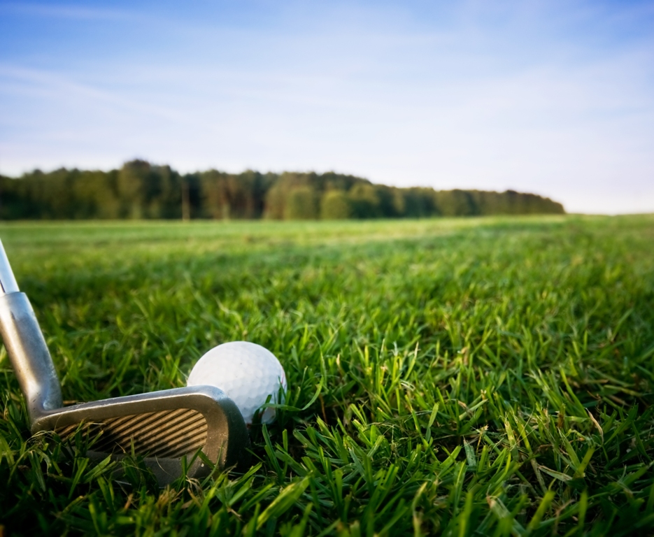 Golf club and ball. Preparing to shot